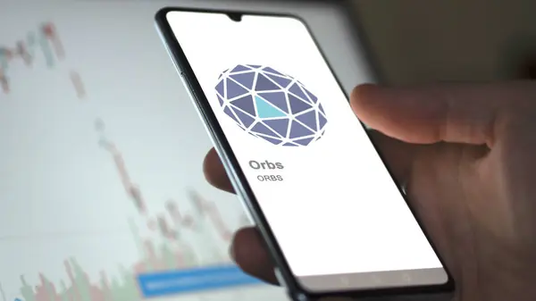 在交易所屏幕上的 Orbs Orbs标志上保持紧密的距离 Orbs Orbs价格股票 设备上的Orbs美元 — 图库照片