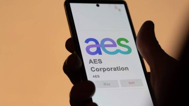 April 09th 2024 , Arlington, Virginia. Close up on logo of AES Corporation on the screen of an exchange. AES Corporation price stocks, $AES on a device. clipart