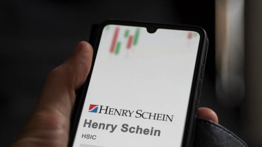 April 09th 2024 , Melville, New York. Close up on logo of Henry Schein on the screen of an exchange. Henry Schein price stocks, $HSIC on a device. clipart