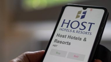 April 09th 2024 , Bethesda, Maryland. Close up on logo of Host Hotels & Resorts on the screen of an exchange. Host Hotels & Resorts price stocks, $HST on a device. clipart