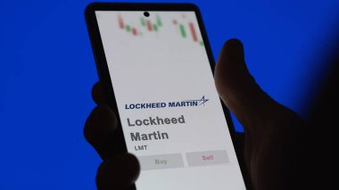 April 09th 2024 , Bethesda, Maryland. Close up on logo of Lockheed Martin on the screen of an exchange. Lockheed Martin price stocks, $LMT on a device. clipart