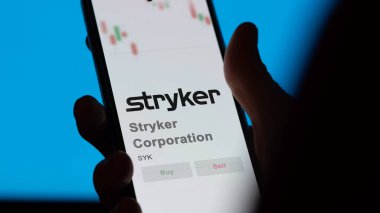 April 09th 2024 , Kalamazoo, Michigan. Close up on logo of Stryker Corporation on the screen of an exchange. Stryker Corporation price stocks, $SYK on a device. clipart