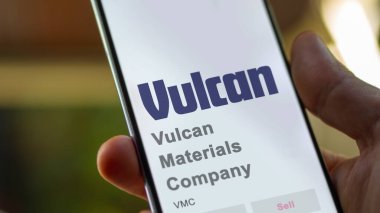April 09th 2024 , Birmingham, Alabama. Close up on logo of Vulcan Materials Company on the screen of an exchange. Vulcan Materials Company price stocks, $VMC on a device. clipart