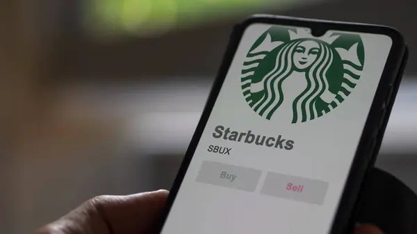 stock image April 09th 2024 , Seattle, Washington. Close up on logo of Starbucks on the screen of an exchange. Starbucks price stocks, $SBUX on a device.