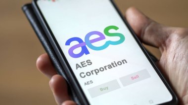 April 09th 2024 , Arlington, Virginia. Close up on logo of AES Corporation on the screen of an exchange. AES Corporation price stocks, $AES on a device. clipart