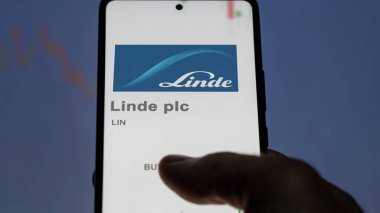 April 09th 2024 , Guildford, United Kingdom. Close up on logo of Linde plc on the screen of an exchange. Linde plc price stocks, $LIN on a device. clipart