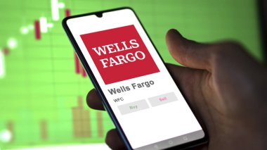 April 09th 2024 , San Francisco, California. Close up on logo of Wells Fargo on the screen of an exchange. Wells Fargo price stocks, $WFC on a device. clipart