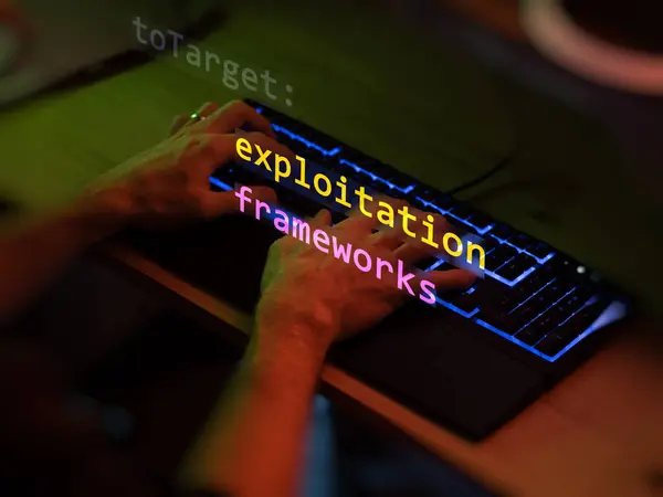 stock image Cyber attack exploitation frameworks text in foreground screen, hands of a anonymous hacker on a led keyboard. Vulnerability text in informatic system style, code on editor screen. Text in English, English text