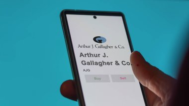29 Nisan 2024, Rolling Meadows, Illinois. Bir değiş tokuş ekranında Arthur J. Gallagher & Co. 'nun logosuna yaklaş. Arthur J Gallagher & Ortak Fiyat Hisseleri, AJG $bir aygıt üzerinde.