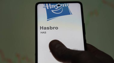 April 09th 2024 , Pawtucket, Rhode Island. Close up on logo of Hasbro on the screen of an exchange. Hasbro price stocks, $HAS on a device. clipart