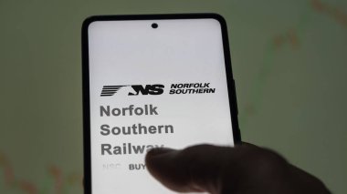 April 09th 2024 , Atlanta, Georgia. Close up on logo of Norfolk Southern Railway on the screen of an exchange. Norfolk Southern Railway price stocks, $NSC on a device. clipart