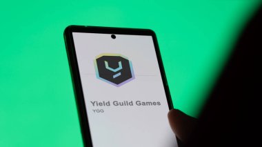 April 17th 2024 , Shanghai, China. Close up on logo of (YGG) Yield Guild Games on the screen of an exchange. (YGG) Yield Guild Games price stocks, $YGG on a device. clipart