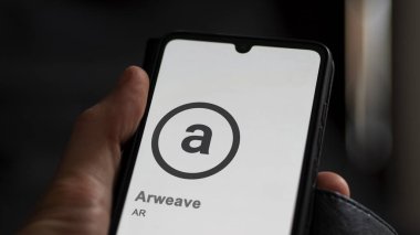 April 17th 2024 , Shanghai, China. Close up on logo of (AR) Arweave on the screen of an exchange. (AR) Arweave price stocks, $AR on a device. clipart