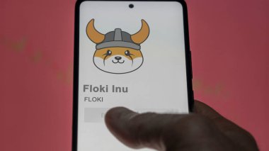 Değiş tokuş ekranındaki FLOKI Floki Inu logosuna yaklaş. FLOKI Floki Inu hisse senetleri, bir cihaza FLOKI $.