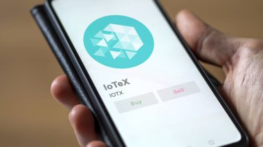 Close up on logo of IOTX IoTeX on the screen of an exchange. IOTX IoTeX price stocks, $IOTX on a device. clipart