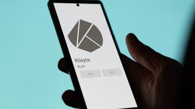 Close up on logo of KLAY Klaytn on the screen of an exchange. KLAY Klaytn price stocks, $KLAY on a device. clipart