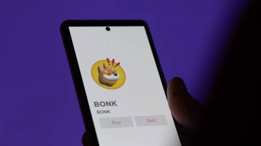Takas ekranındaki BONK BONK logosuna yaklaş. BONK BONK fiyat hisseleri, bir aygıt BONK $.