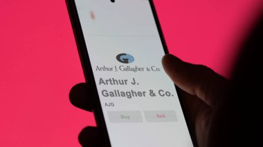 April 09th 2024 , Rolling Meadows, Illinois. Close up on logo of Arthur J. Gallagher & Co. on the screen of an exchange. Arthur J  Gallagher & Co  price stocks, $AJG on a device. clipart