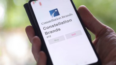 April 09th 2024 , Victor, New York. Close up on logo of Constellation Brands on the screen of an exchange. Constellation Brands price stocks, $STZ on a device. clipart