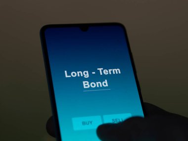 An investor analyzing the long - term bond etf fund on a screen. A phone shows the prices of Long - Term Bond clipart