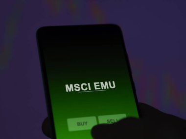 An investor analyzing the msci emu etf fund on a screen. A phone shows the prices of MSCI EMU clipart