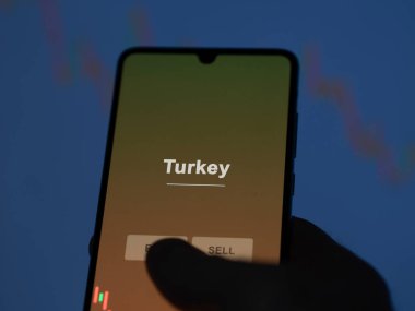 An investor analyzing the turkey etf fund on a screen. A phone shows the prices of Turkey clipart