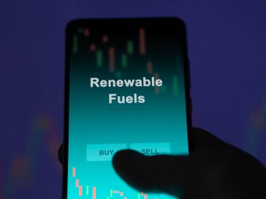 An investor analyzing the renewable fuels etf fund on a screen. A phone shows the prices of Renewable Fuels clipart