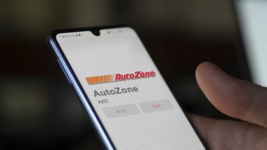 Memphis, Tennessee. Close up on logo of AutoZone on the screen of an exchange. AutoZone price stocks, $AZO on a device. clipart