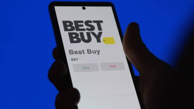 Richfield, Minnesota. Close up on logo of Best Buy on the screen of an exchange. Best Buy price stocks, $BBY on a device. clipart