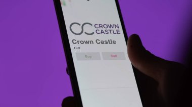 Houston, Texas. Close up on logo of Crown Castle on the screen of an exchange. Crown Castle price stocks, $CCI on a device. clipart