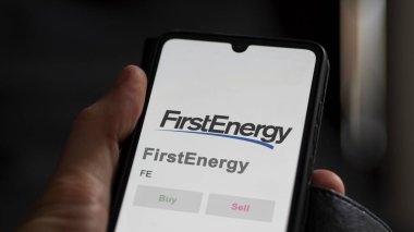 Akron, Ohio. Close up on logo of FirstEnergy on the screen of an exchange. FirstEnergy price stocks, $FE on a device. clipart