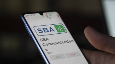 Boca Raton, Florida. Close up on logo of SBA Communications on the screen of an exchange. SBA Communications price stocks, $SBAC on a device. clipart