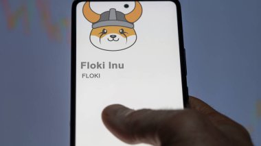 Bir değiş tokuş ekranındaki FLOKI Floki Inu şifreleme varlığının logosunu kapat. FLOKI Floki Inu hisse senetleri, bir cihaza FLOKI $.