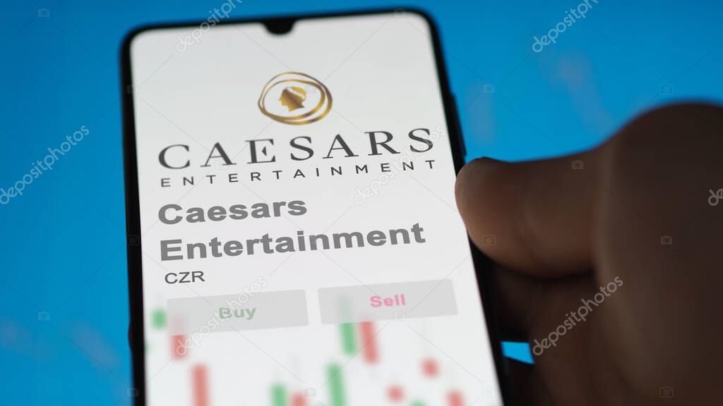 Reno, Nevada. Close up on logo of Caesars Entertainment on the screen of an exchange. Caesars Entertainment price stocks, $CZR on a device.