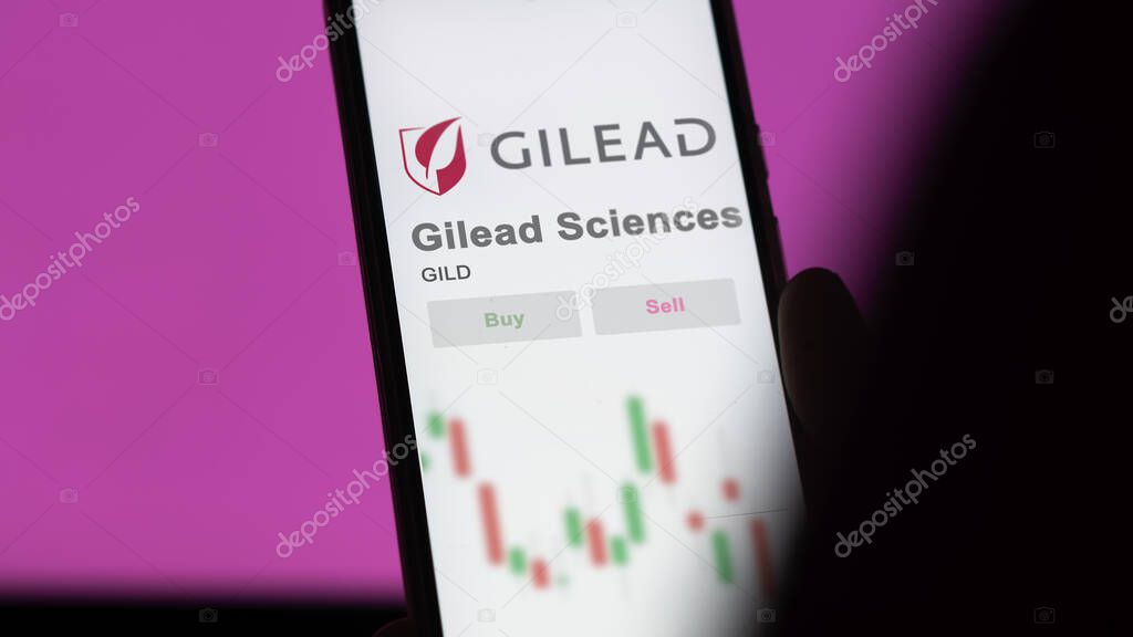 Foster City, California. Close up on logo of Gilead Sciences on the screen of an exchange. Gilead Sciences price stocks, $GILD on a device.