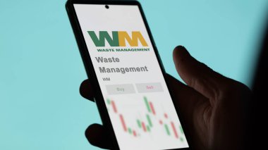 Houston, Teksas. Bir değiş tokuş ekranındaki Atık Yönetimi logosuna yaklaş. Atık Yönetimi hisse senetleri, bir aygıt için WM $.