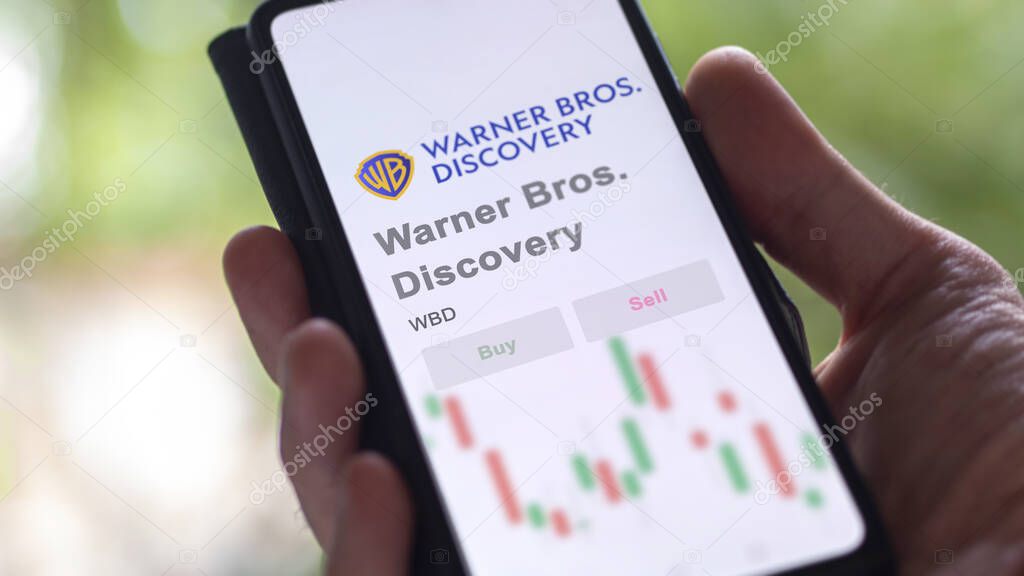 New York City, New York. Close up on logo of Warner Bros. Discovery on the screen of an exchange. Warner Bros  Discovery price stocks, $WBD on a device.