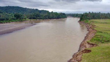 Aerial drone of Saddang River, abrasion disaster, erosion on the banks of the Saddang River, in Masolo Village, Teppo Subdistrict, Indonesia clipart