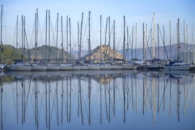 Denizci yatları mavi gökyüzüne karşı suya yansır. Marmaris Şehri. Türkiye