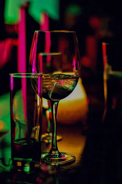 stock image Wine glass, Cocktail glass, Empty beverage glass Placed on a bar, in a restaurant, in the dim light