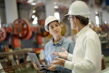 Metal levha fabrikasında yeni nesil mühendisler. Denetmenlerden ya da meslektaşlardan çalışma yöntemleri öğrenme ve kendi başınıza öğrenim görmeniz profesyonelce öğretilmelidir.