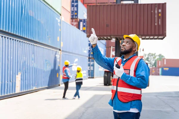 stock image male engineers in a container shipping company Consulting to check the order for the container that is responsible