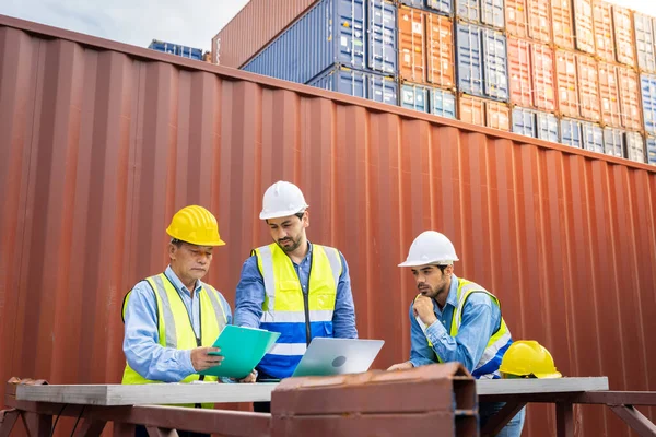 stock image Group male engineers in a container shipping company Consulting to check the order for the container that is responsible