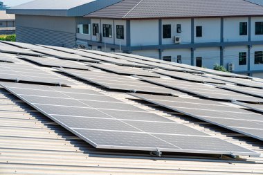 Many solar panels are installed on the factory roof.