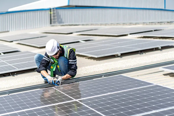 Male engineer installing or checking the working condition of solar panels on the roof or at the height of the factory for saving electricity was broken to use renewable energy from the sun