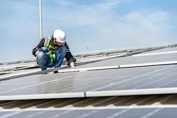 Male engineer installing or checking the working condition of solar panels on the roof or at the height of the factory for saving electricity was broken to use renewable energy from the sun
