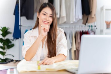 Asian women working together Small business, SME, tailoring designs for customers. Both of them acted as great designers.