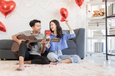 Asian couple Showing love surprise giving flowers or gifts to each other on important occasions such Valentine's Day birthdays or wedding anniversaries with love and warmth in bedroom of their home