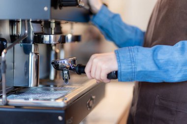 coffee shop lady is preparing the equipment for the opening of the shop to serve coffee drinks to customers with standard service, cleanliness and international taste.