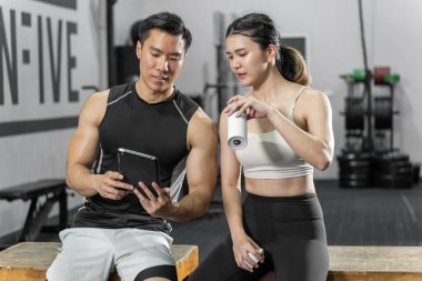 Asian men and women Have a strong body, good health, love to exercise. They are exercising together at the gym having fun.	